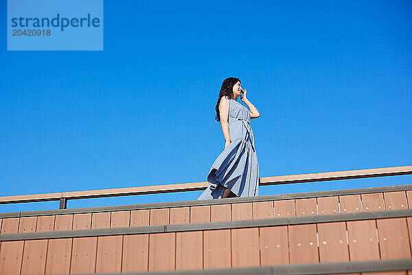 Japanese woman against blue sky