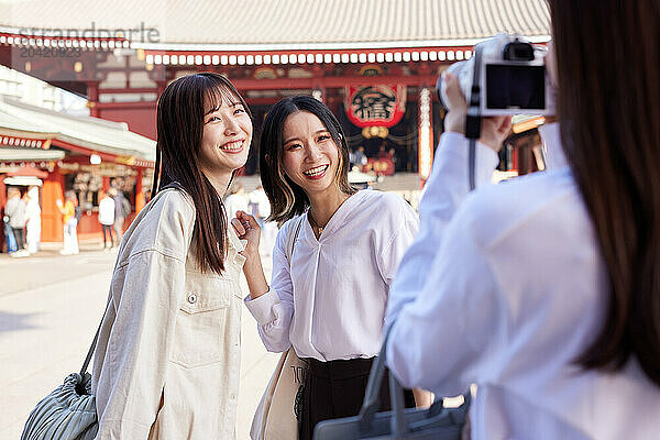 Japanese friends visiting traditional temple in Tokyo