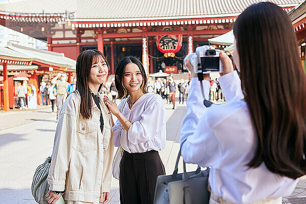 Japanese friends visiting traditional temple in Tokyo