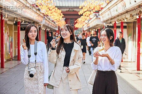 Japanese friends visiting traditional temple in Tokyo