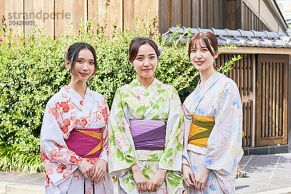 Japanese friends wearing yukata visiting traditional area in Tokyo