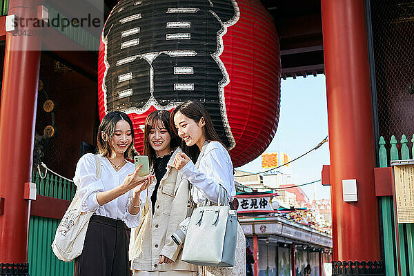 Japanese friends visiting traditional temple in Tokyo