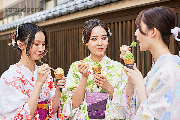 Japanese friends wearing yukata visiting traditional area in Tokyo