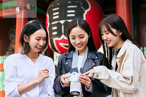 Japanese friends visiting traditional temple in Tokyo