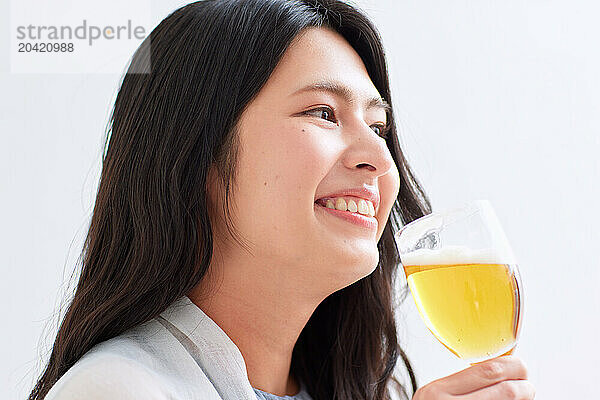 Japanese woman holding a glass of beer