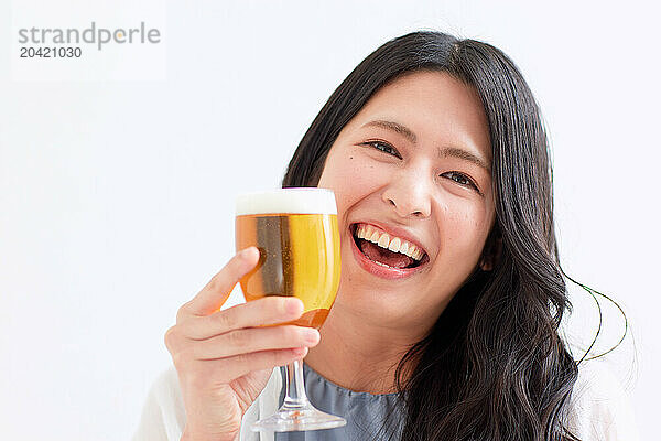 Japanese woman holding a glass of beer