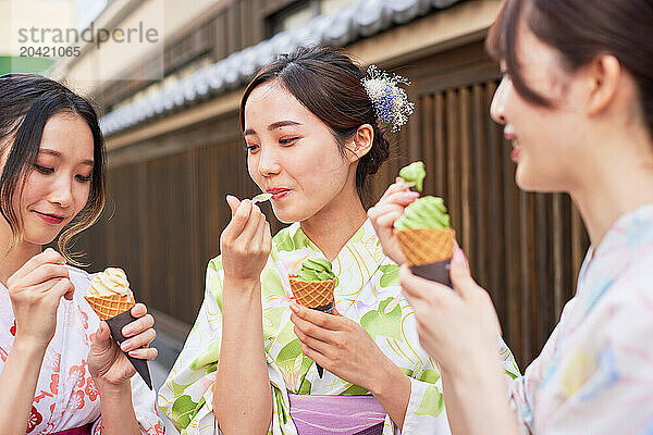 Japanese friends wearing yukata visiting traditional area in Tokyo