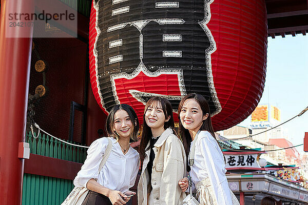 Japanese friends visiting traditional temple in Tokyo