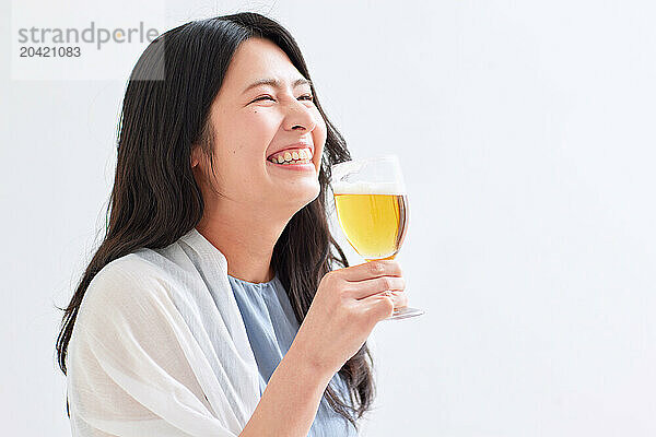 Japanese woman holding a glass of beer