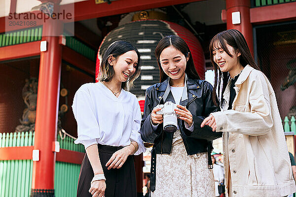 Japanese friends visiting traditional temple in Tokyo