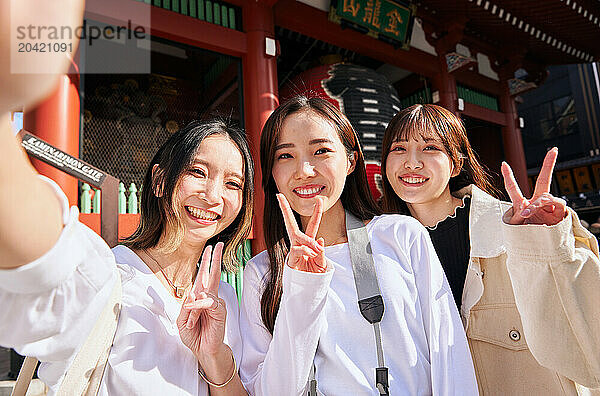 Japanese friends visiting traditional temple in Tokyo