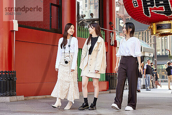 Japanese friends visiting traditional temple in Tokyo