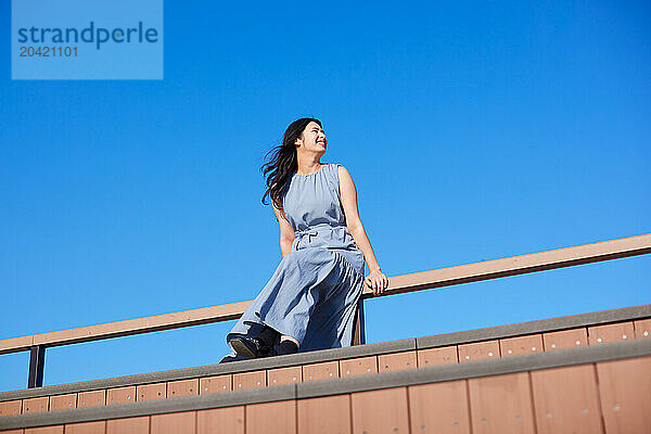 Japanese woman against blue sky