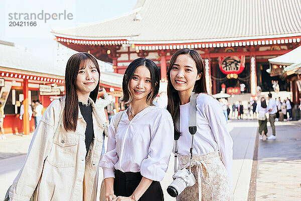 Japanese friends visiting traditional temple in Tokyo