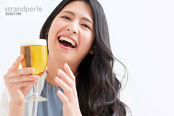 Japanese woman holding a glass of beer