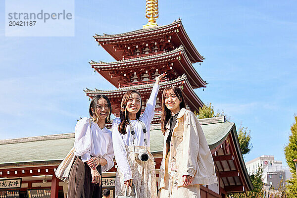 Japanese friends visiting traditional temple in Tokyo