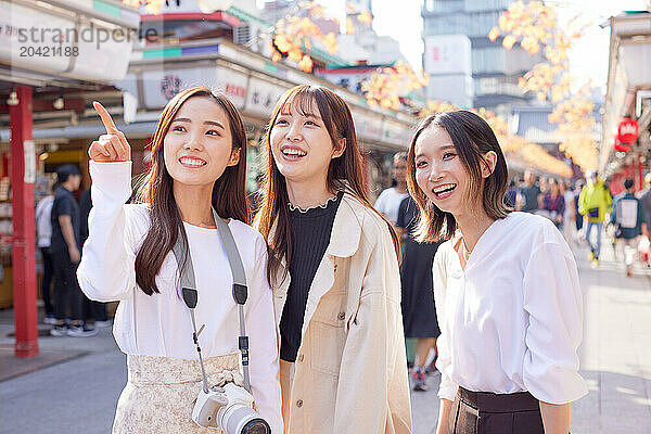 Japanese friends visiting traditional temple in Tokyo