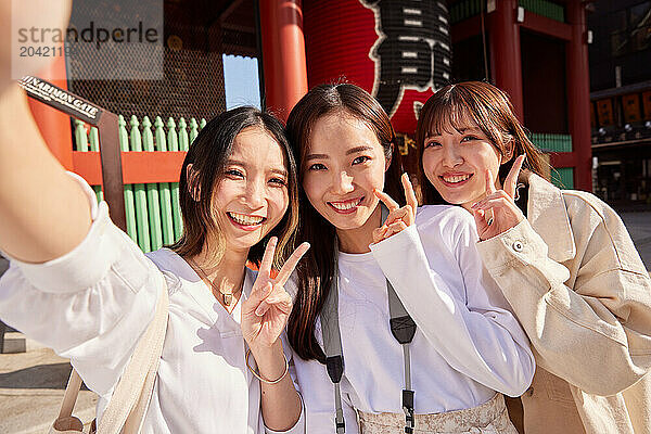 Japanese friends visiting traditional temple in Tokyo