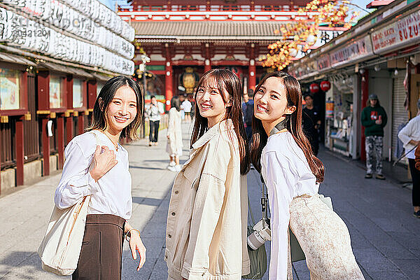 Japanese friends visiting traditional temple in Tokyo