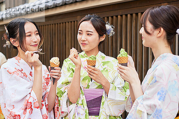 Japanese friends wearing yukata visiting traditional area in Tokyo