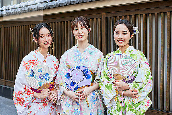 Japanese friends wearing yukata visiting traditional area in Tokyo