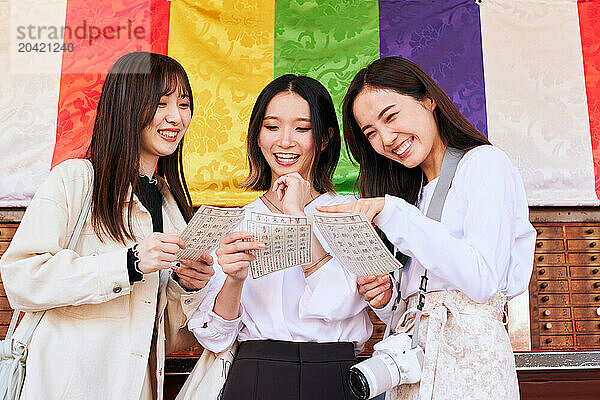 Japanese friends visiting traditional temple in Tokyo