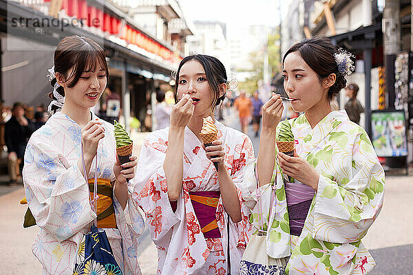 Japanese friends wearing yukata visiting traditional area in Tokyo