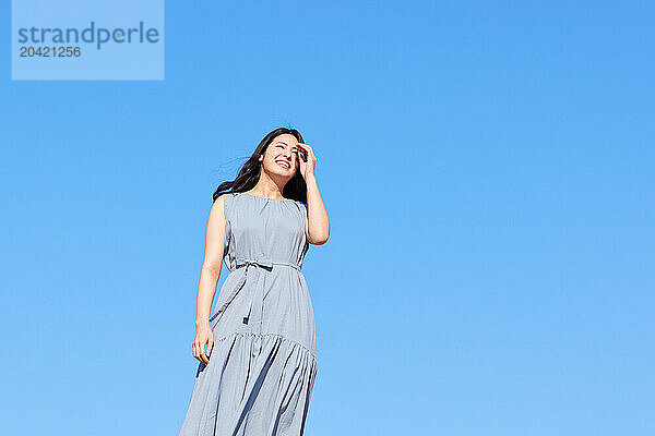 Japanese woman against blue sky