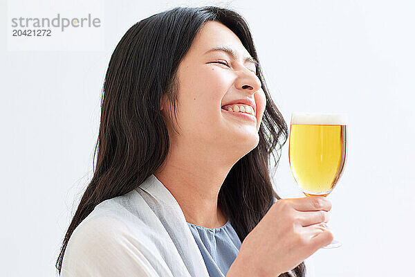 Japanese woman holding a glass of beer