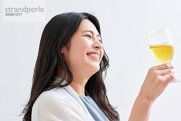 Japanese woman holding a glass of beer