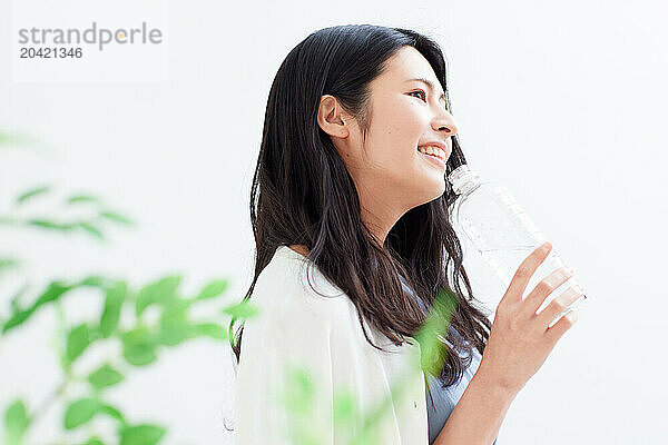 Japanese woman holding a bottle of water