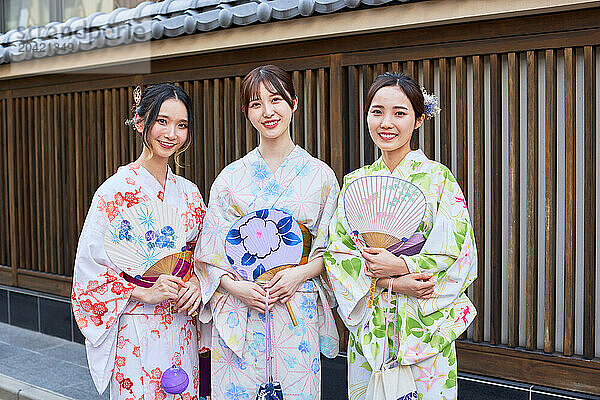 Japanese friends wearing yukata visiting traditional area in Tokyo