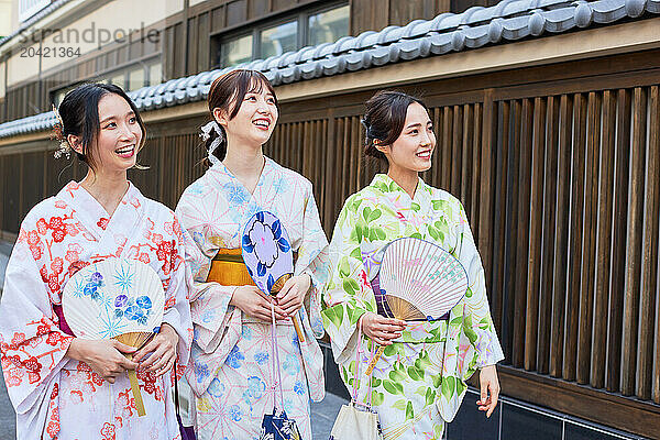 Japanese friends wearing yukata visiting traditional area in Tokyo