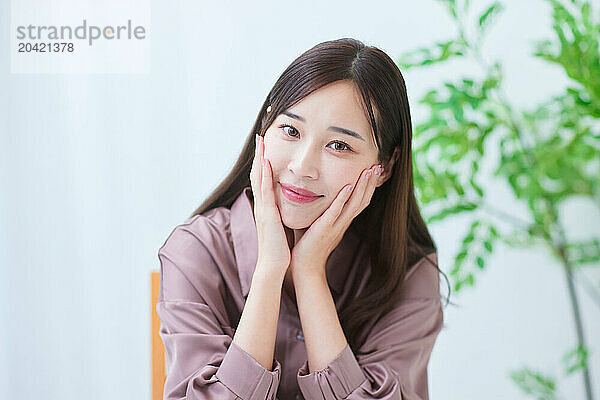 beautiful Japanese woman smiling while sitting at a table