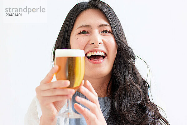 Japanese woman holding a glass of beer