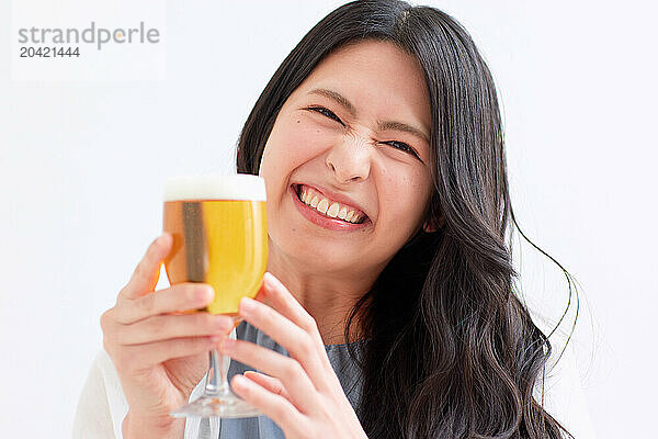 Japanese woman holding a glass of beer