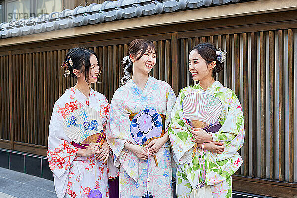 Japanese friends wearing yukata visiting traditional area in Tokyo