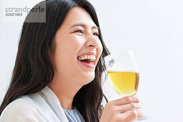 Japanese woman holding a glass of beer