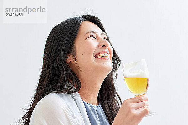 Japanese woman holding a glass of beer