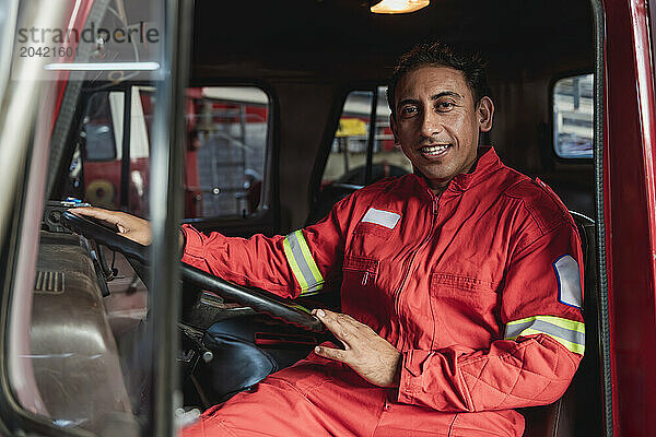 Portrait of fire truck driver smiling at fire station