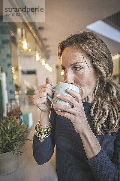 Woman having a capuccino in a bar  vintage modern style  barcelo