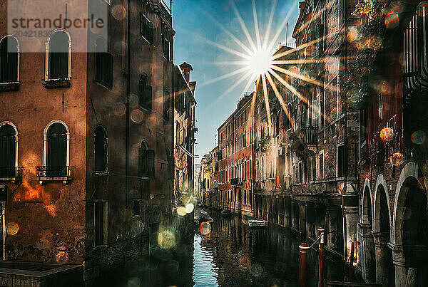 View of old buildings on canal in Venice  Italy on bright sunny day.