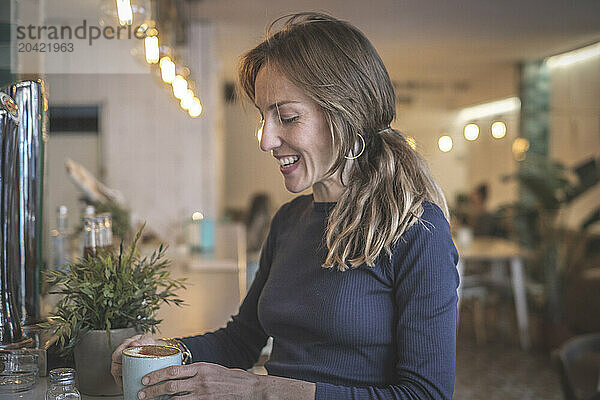 Woman having a capuccino in a bar  vintage modern style  barcelo