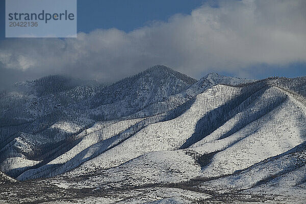 Snowy mountains outside of Salt Lake City catch the last light o