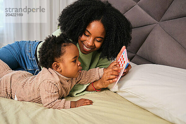 Cuban mother teaching words and numbers to her toddler daughter.