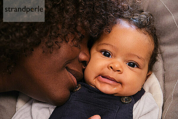 African woman with her baby girl  scene is warm and loving.