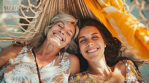 Two women are laying on a hammock  smiling and enjoying the sun