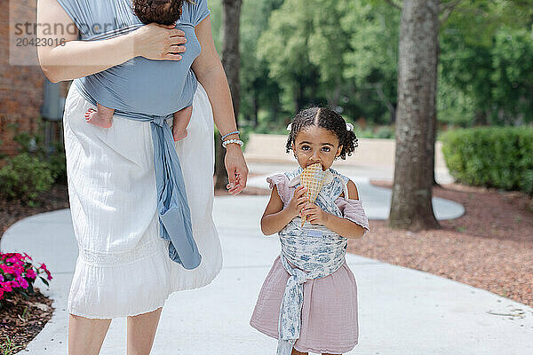 mother and daughter walking with ice cream