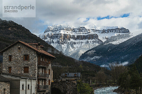 View of snow-capped mountains from a village in the Spanish Pyrenees.