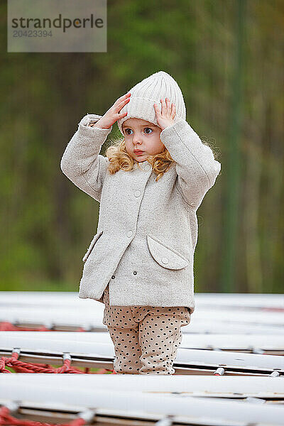 Portrait of a little girl on a playground in a city park